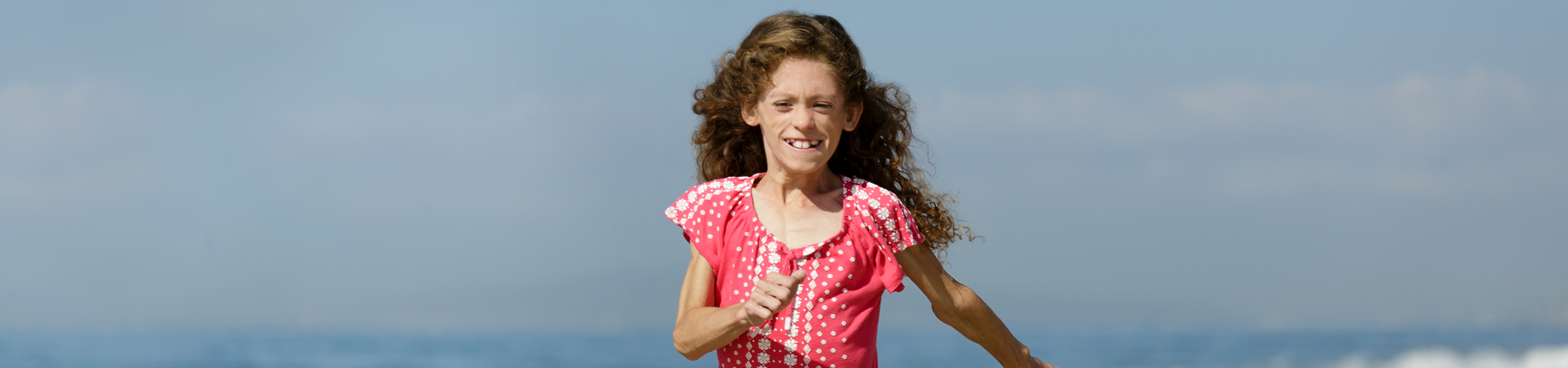Girl with GL running on the beach